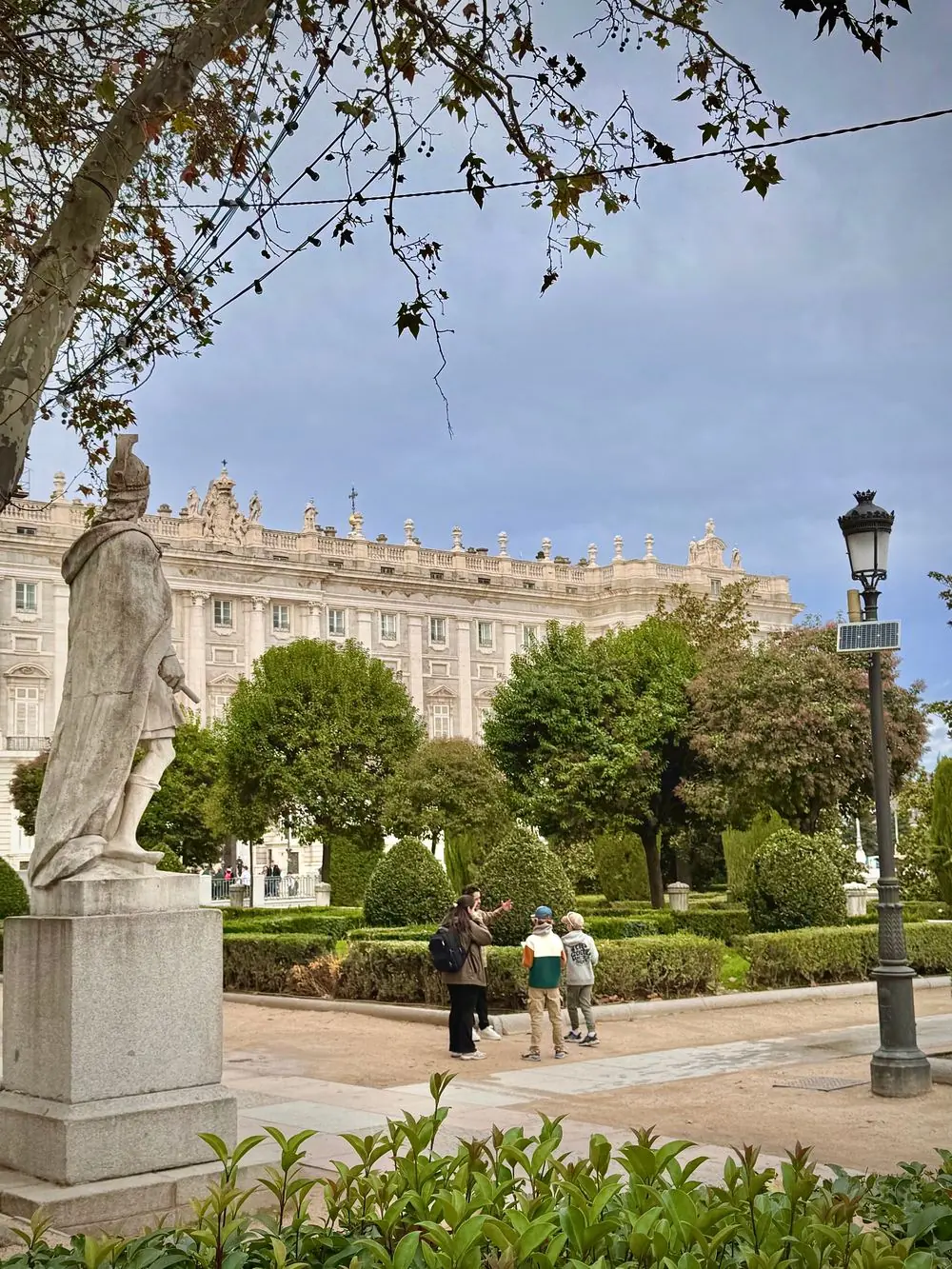 Statue and gardens in Plaza de Oriente in front of the Royal Palace